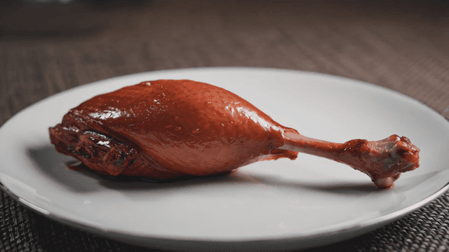 Grilled chicken leg on plate