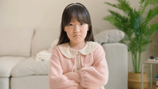 Child crossing her arms in anger