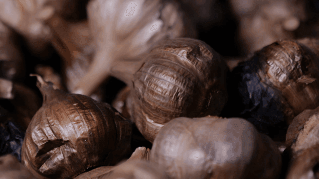 Close-up of black garlic bulbs