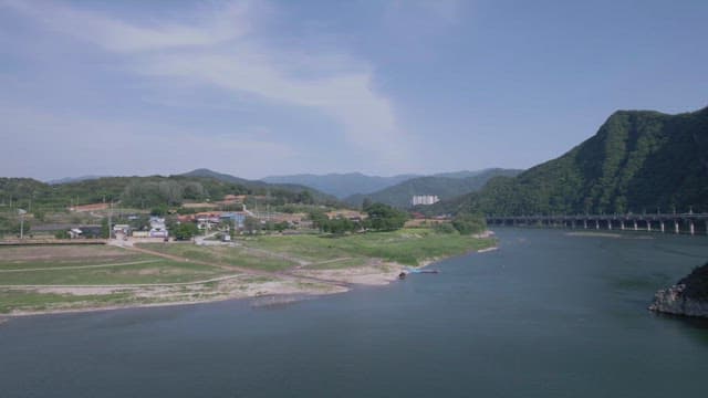 Serene Village Surrounded by Green Mountains and Rivers