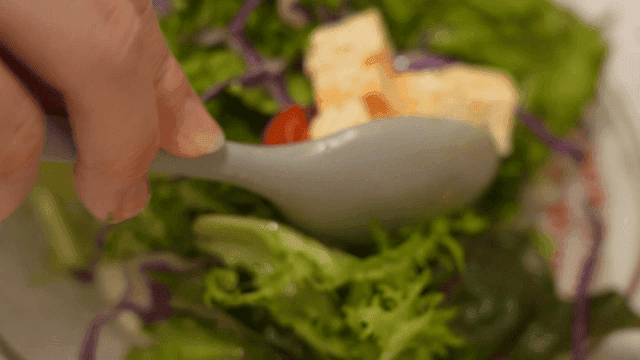 Salad topped with tofu and cherry tomatoes