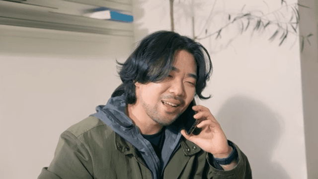 Man finishing a phone call with a pleasant expression