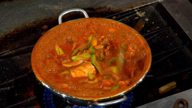 Spicy pork stew boiling in a pot