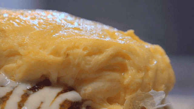 Okonomiyaki topped with a soft steaming omelet