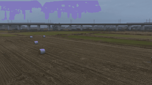 Large farmland with haystacks and roads