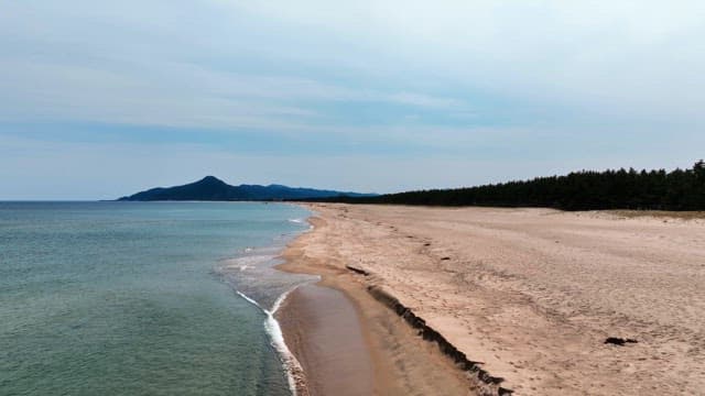 Serene beach with distant mountains