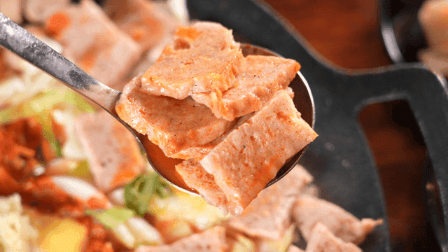 김이 나는 부대볶음 햄 조각들을 퍼낸 국자