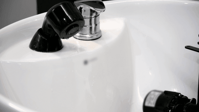 Clean beauty salon faucet with water droplets