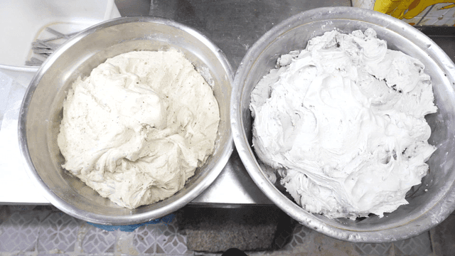 Two bowls of dough on a kitchen counter