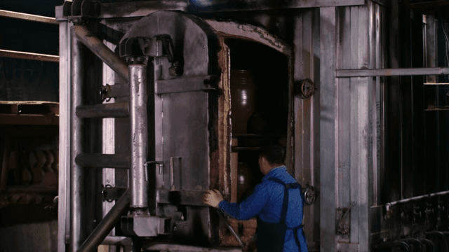 Worker inspecting a large industrial machine