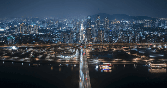 A bustling cityscape at night with lights