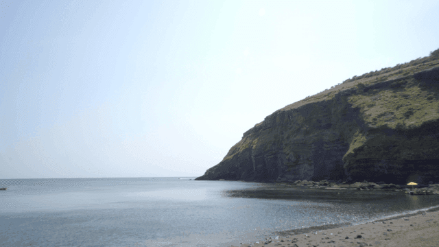 Tranquil beach with rocky cliffs