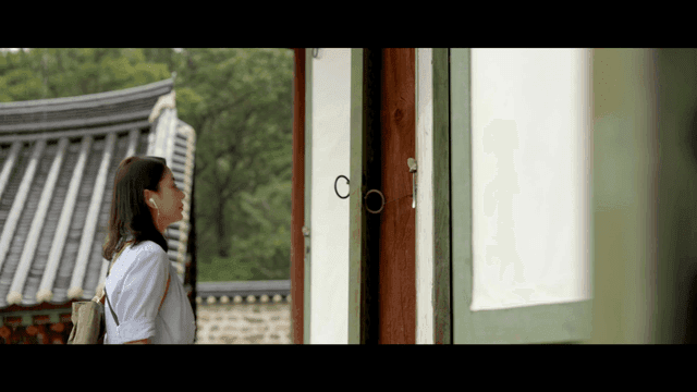 Woman praying with her hands clasped at traditional temple