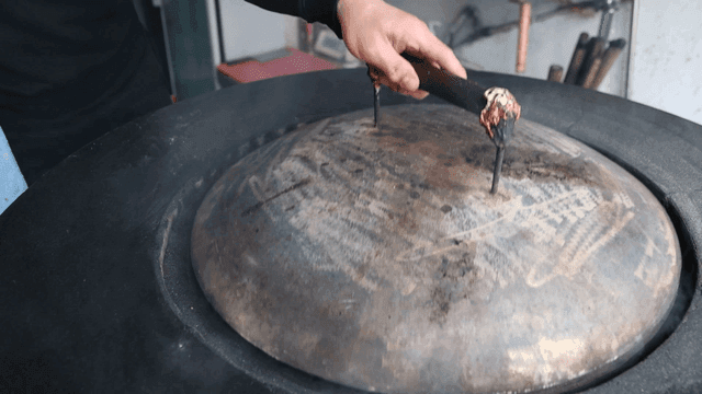 Hand lifting lid of large pot