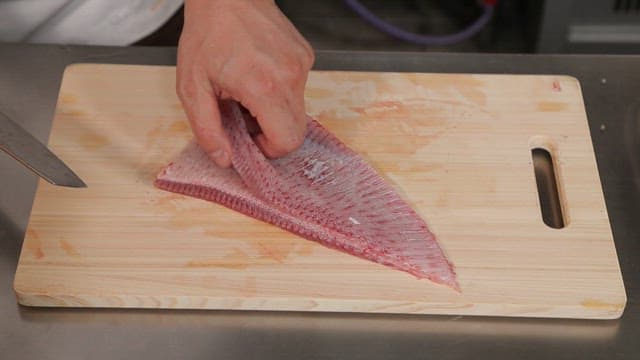 Filleting a tingray on a cutting board