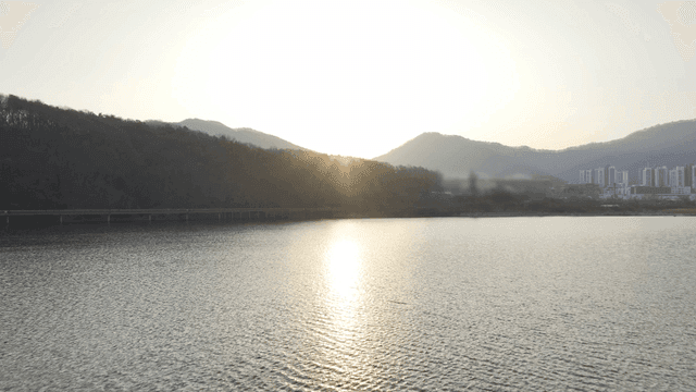 Sunset over a serene lake with mountains