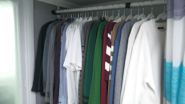 Various clothes hanging neatly in room
