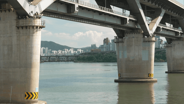 Han River flowing beneath large concrete bridge connecting city