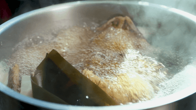 Boiling fish broth with kelp and ingredients