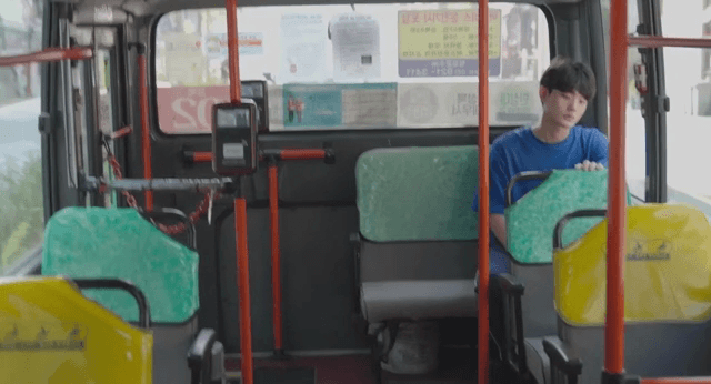 Man sitting alone on a bus, lost in thought