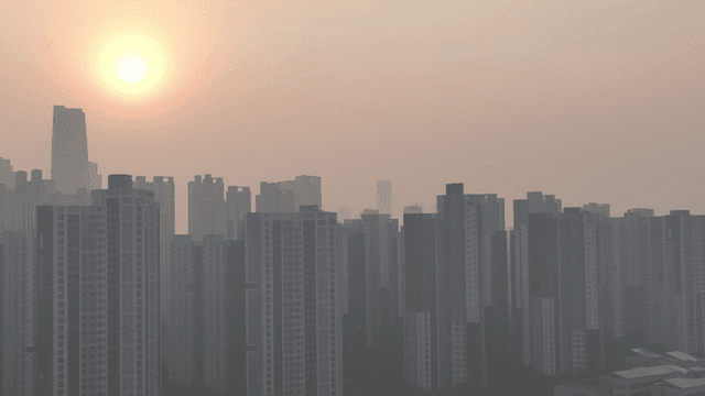 Sunrise over a city skyline with tall buildings