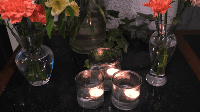 Candles and flowers on a dark table