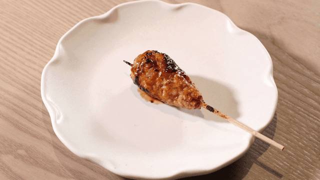 Chicken meatball skewers on white plate