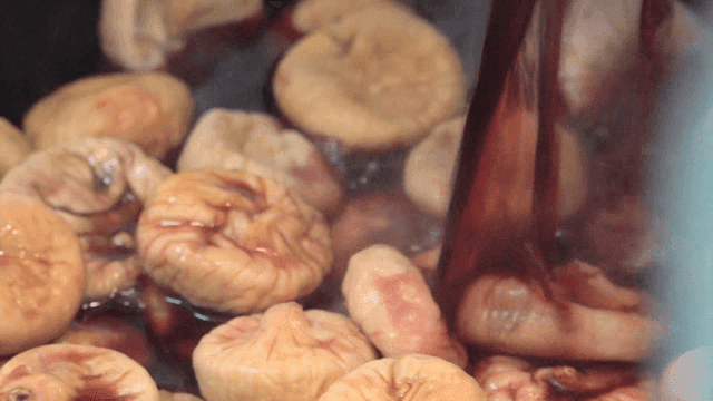 Mulled wine being poured over dried figs