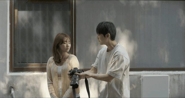 Couple conversing outdoors with a camera