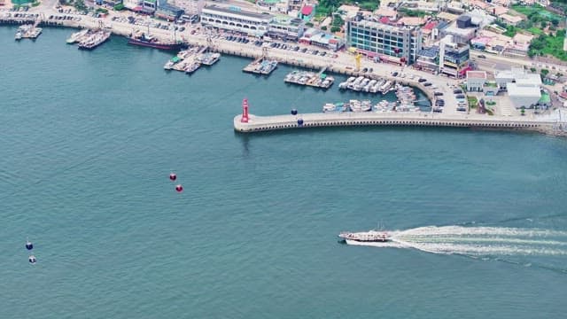 Coastal city with cable cars and boats