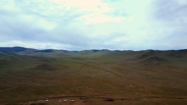 Vast mountain landscape under a cloudy sky