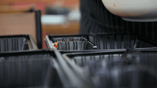 Preparing food with tongs in a kitchen