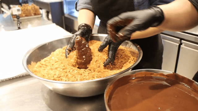 Cereal sprinkled on chocolate-coated bread
