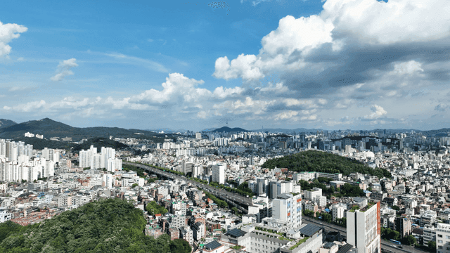 Panoramic view of city spread out under blue sky