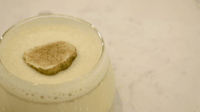 Creamy beverage with a dried lime slice