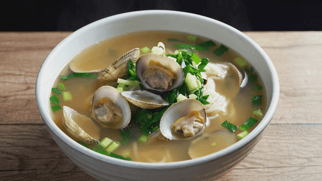 Clam kalguksu in white bowl