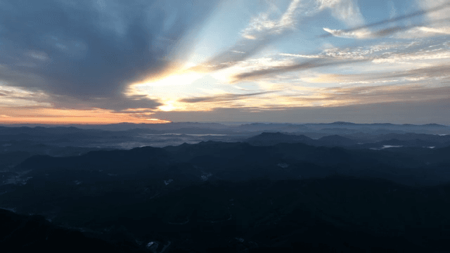 Sunrise over a vast mountain range