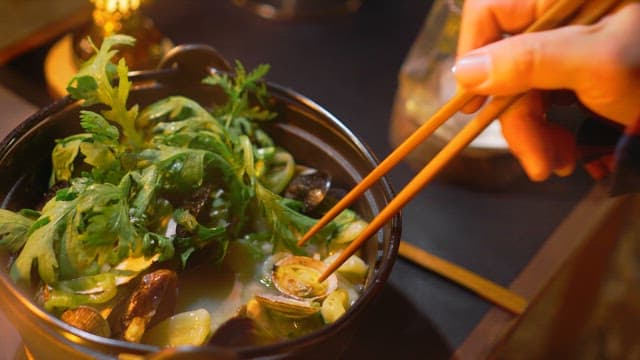 Person Enjoying Chewy Clam Meat