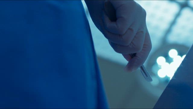 Surgeon Preparing with a Scalpel Before Surgery