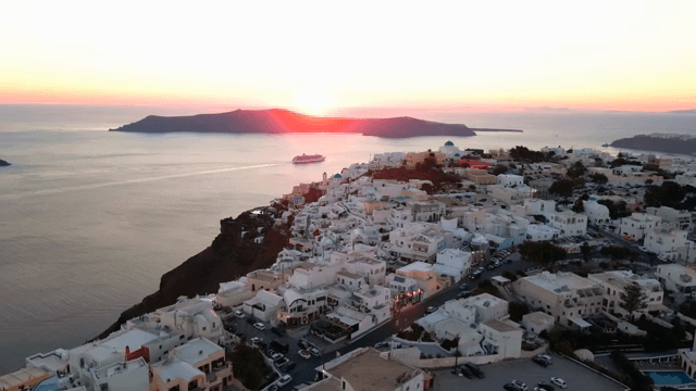 Sunset over a coastal village with white buildings
