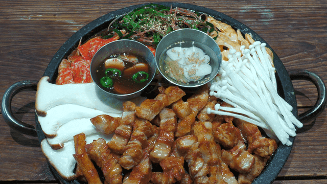 Grill pan with grilled pork belly and vegetables