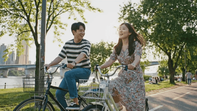 A couple cycling in a city park