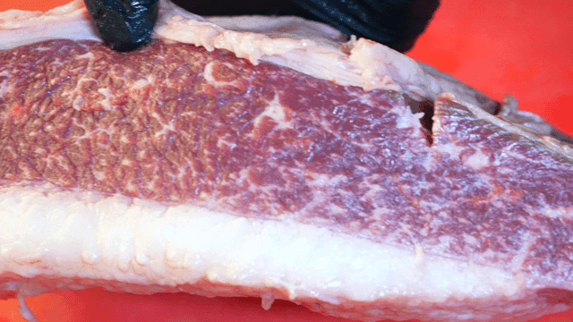 Marbled beef brisket on cutting board