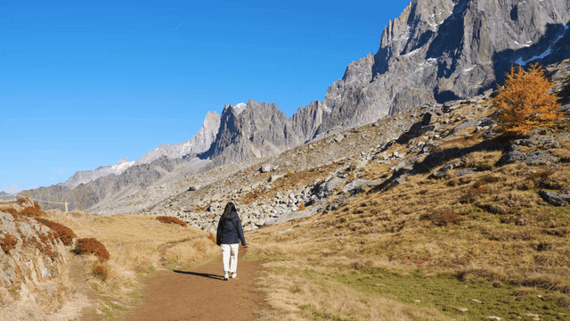 Back view of woman walking on mountain path