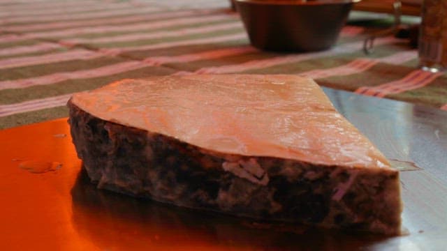 Spice sprinkled on fish steaks prepared on a cutting board