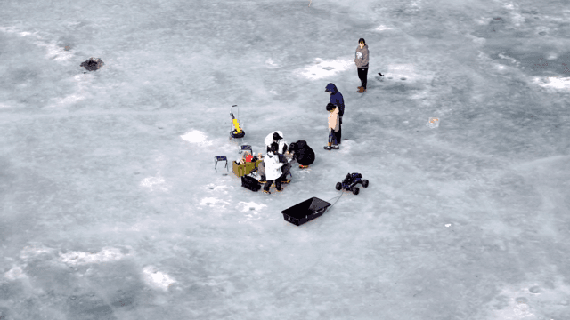 얼어붙은 호수에서 얼음 낚시하는 사람들