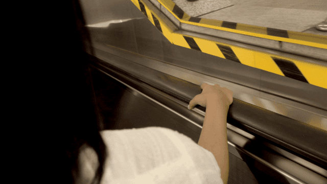 Person holding the handrail on an escalator