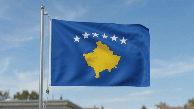 Kosovo flag fluttering under clear sky