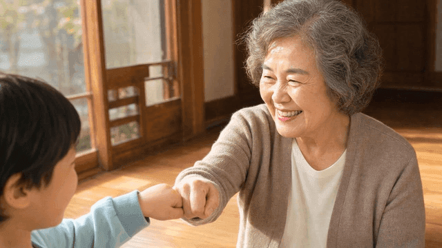 Grandmother and child sharing a fist bump