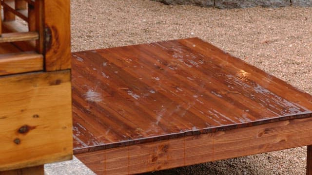 Raindrops falling on a wooden platform in Hanok